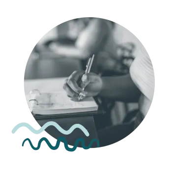 Image of a person writing in a notebook